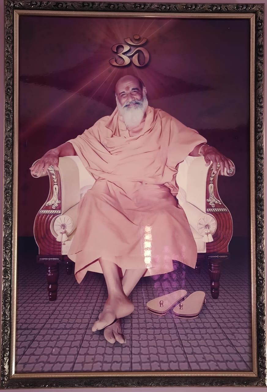 Framed portrait of a Swami with Om symbol